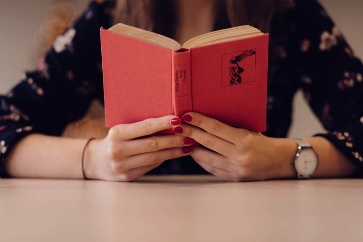 woman reading book- how to stop worrying about what people think of you