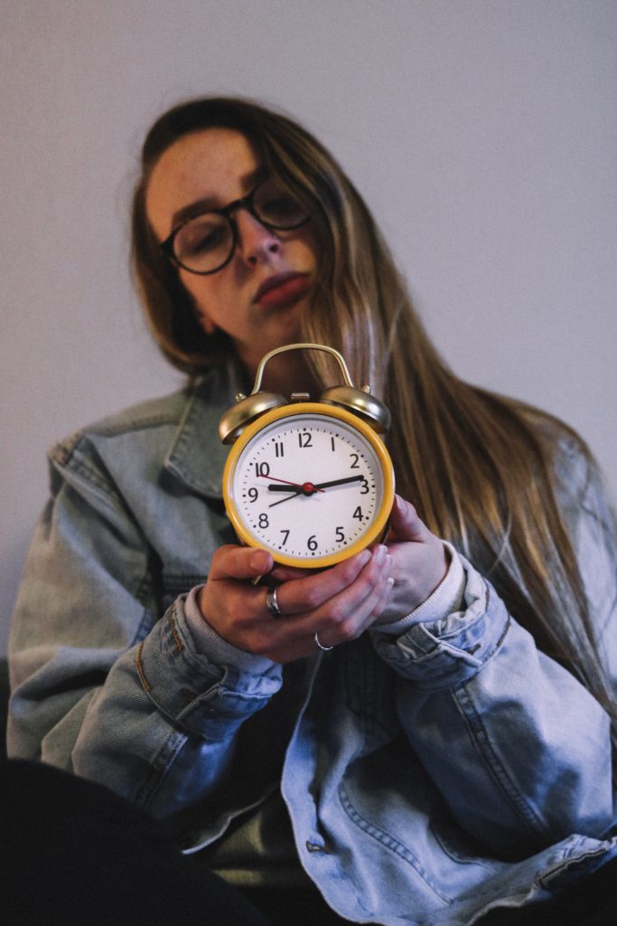 lady with alarm clock-morning routine of successful people