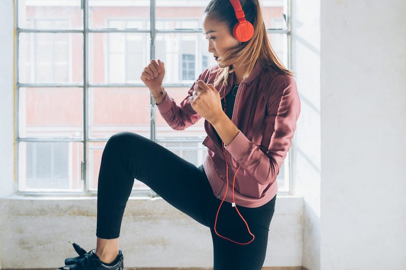 How to overcome limiting beliefs- a woman wearing headphones