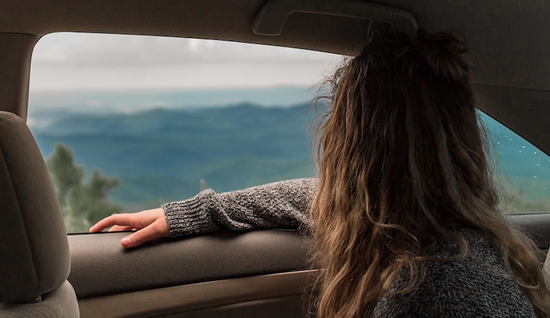 How to overcome limiting beliefs- a woman sitting in a car