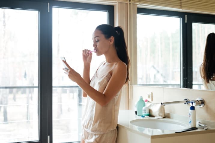 Girl in bathroom using phone