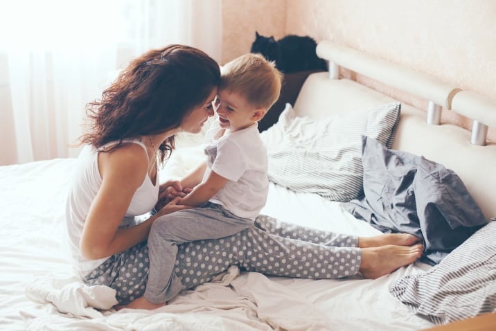 mom cuddling with son- productive sunday habits