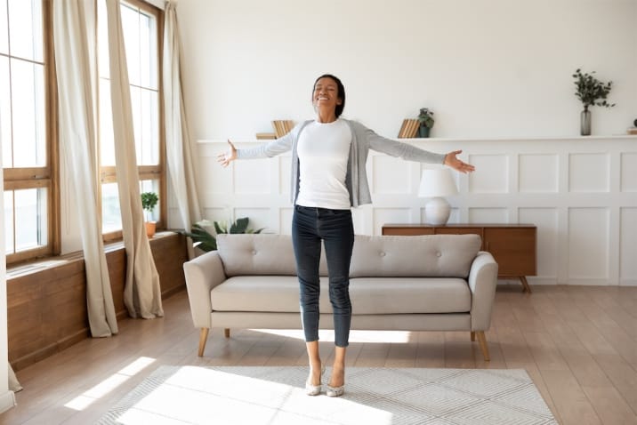 a woman standing happily