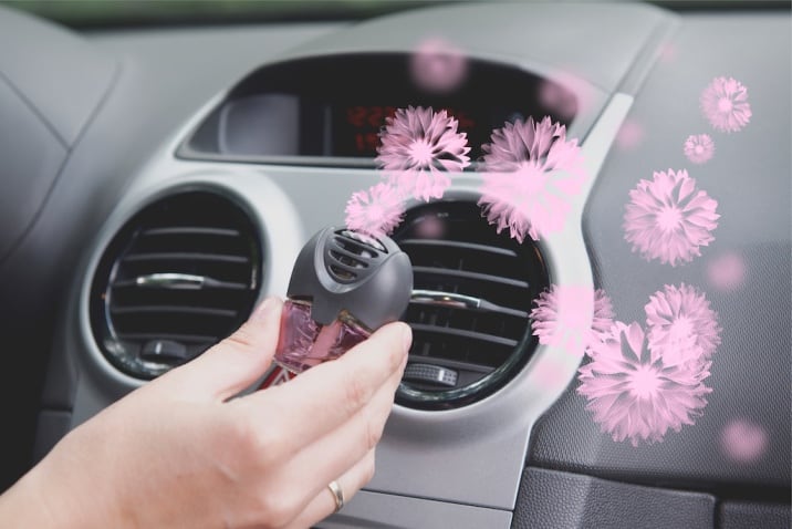 a person holding a car freshener